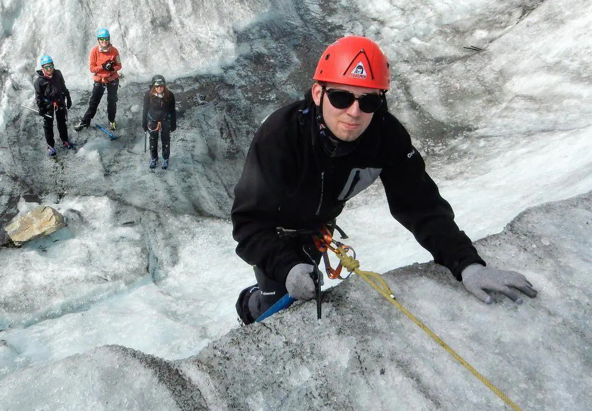 Photo of Nicolas climbing a small ice wall
